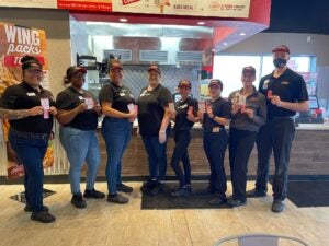 Employees at Charleys Philly Steaks in Converse, Texas during the grand opening celebration.