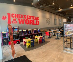 Chairs and arcade games in Charleys Philly Steaks and Wings in BITES Langley Park, located in Hyattsville, Marylad.