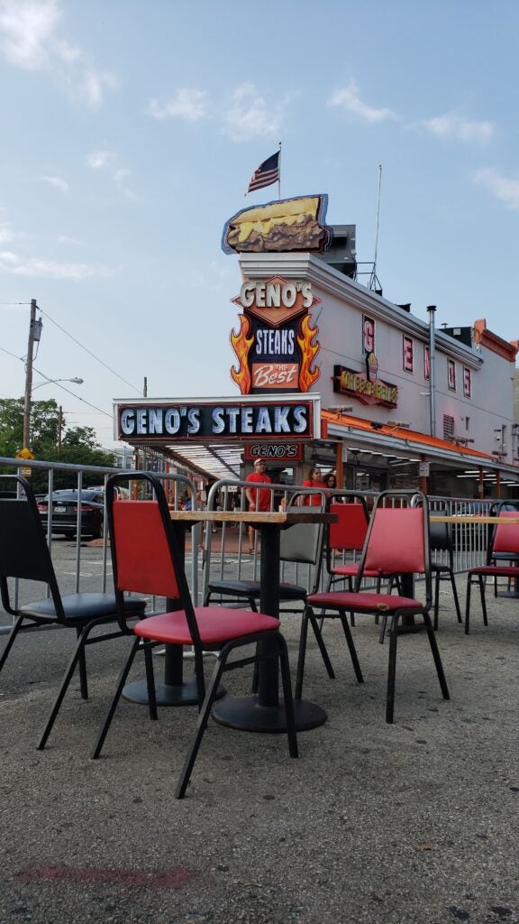 Image of chairs and a table outside of Geno's Steak in Philadelphia, Pennsylvania. Another early innovator of original cheesesteaks in Philadelphia.