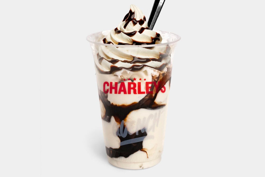 A chocolate sundae from Charleys Cheesesteaks made with vanilla soft serve ice cream and topped with chocolate syrup.