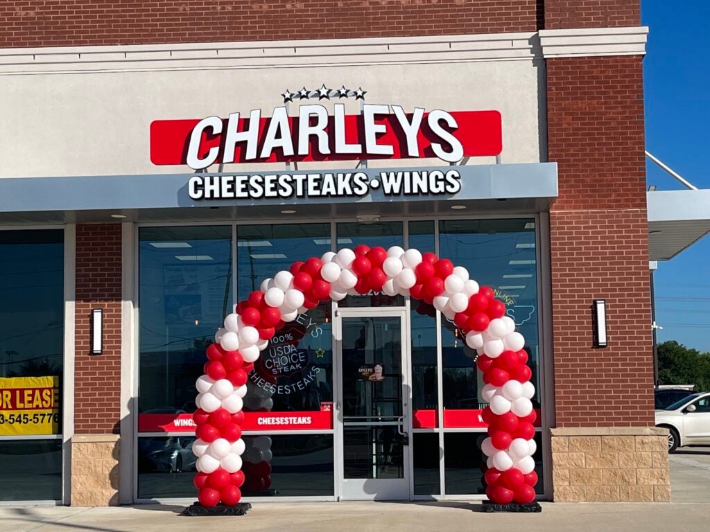 The store front and grand opening ribbon at Charleys Cheesesteaks FM 1960.