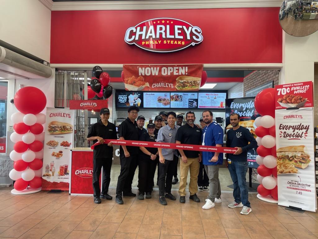 The grand opening team at Newburgh, NY standing in front of the entrance to Charleys Cheesesteaks and Wings.