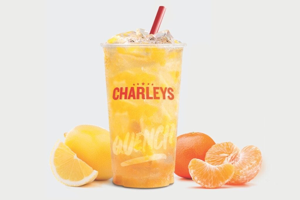 The Tangerine Lemonade from Charleys, surrounded by peeled tangerine pieces.