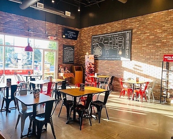 Tables and chairs in the dining area at Charleys Cheesesteaks and Wings, South Main Street Plaza, in Houston, Texas.