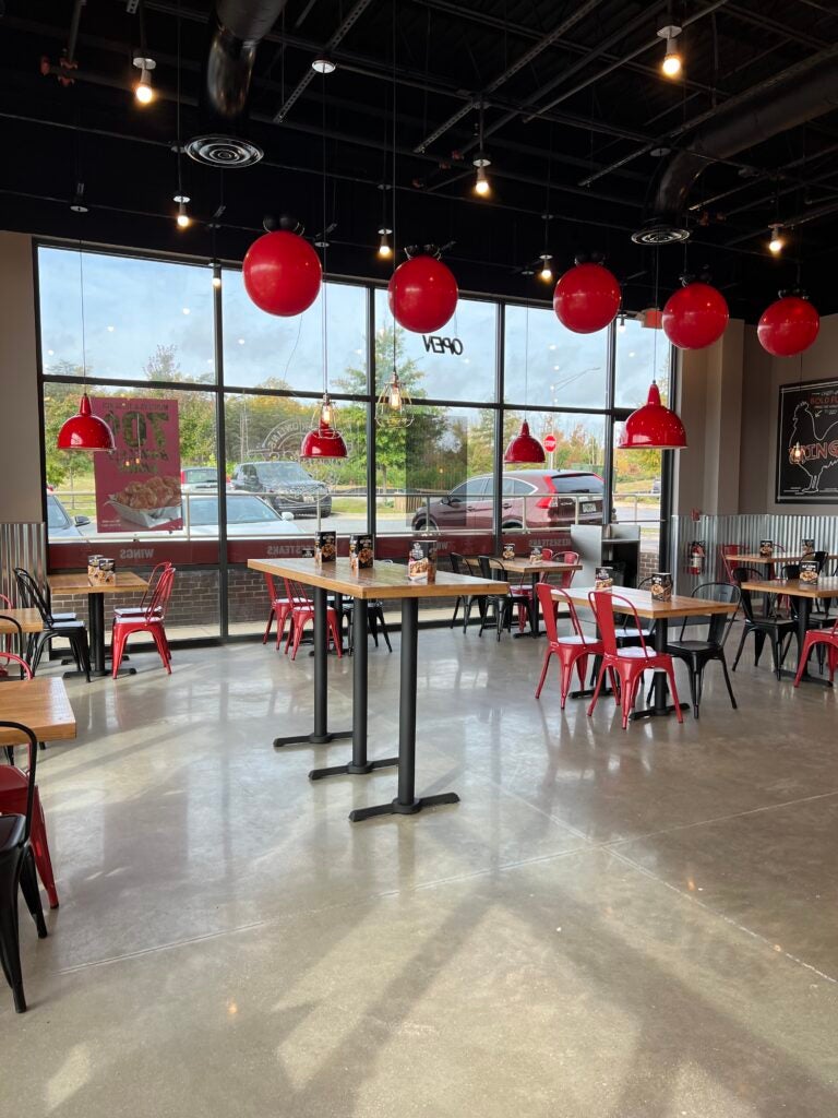 Tables and chairs in the dining area at Charleys Cheesesteaks and Wings at Cadillac Crossing in Brandywine, MD.