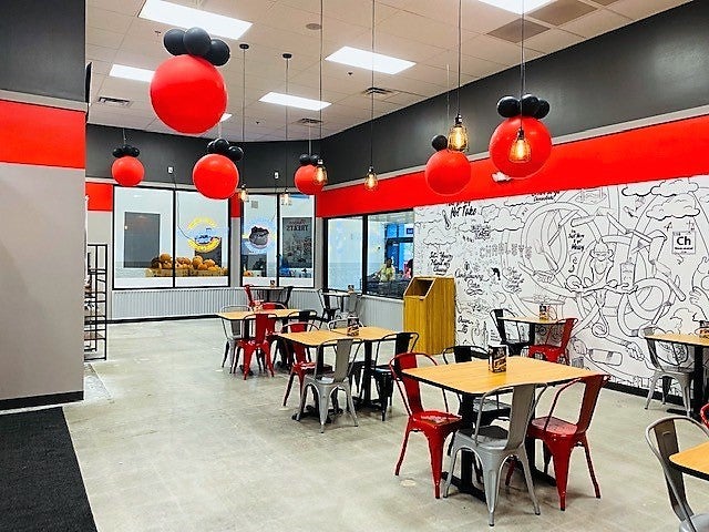 The dining area with chairs and tables at Charleys Cheesesteaks and Wings at Walmart - Highway 6. 