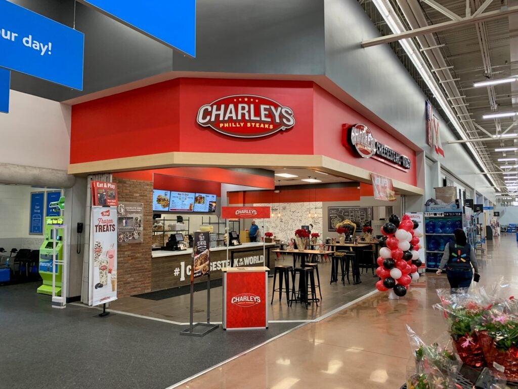 The front entrance of Charleys Cheesesteaks and Wings during grand opening at Juliet Blvd. Walmart in Naples, FL.  This features the front entrance of the store with signs and balloons to celebrate the grand opening. 