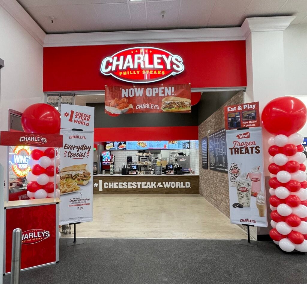 Charleys Cheesesteaks and Wings at Brighton Walmart during their grand opening in November 2022. This features the front entrance and signs for Charleys, including balloon pillars.