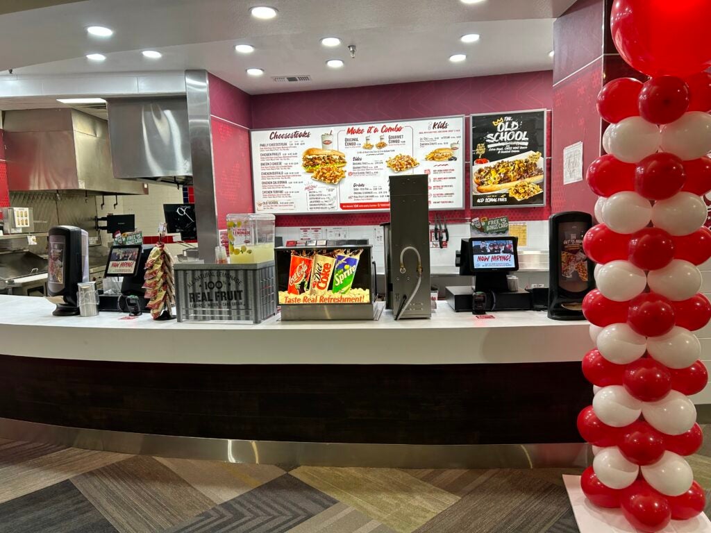 The front counter at Charleys Cheesesteaks and Wings in Music City Mall during our grand opening in November 2022. Here you can see the menu, registers, and balloon pillars for the grand opening.