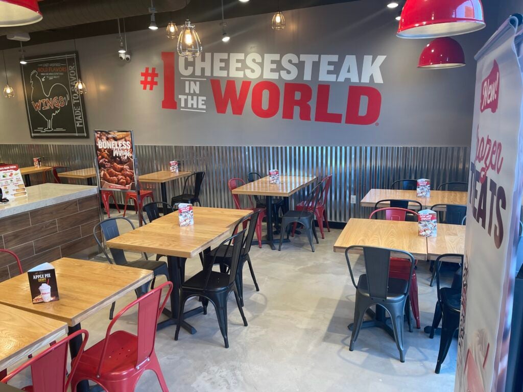 The tables and chairs in the dining area at Charleys Cheesesteaks and Wings at Fulton Ave. Charleys Hempstead. Cheesesteak Hempstead, cheesesteak near me.