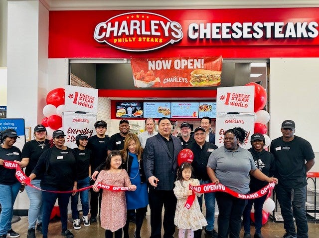 Restaurant owner Daniell Yoo and the team at Uptown Blvd. Cedar Hill Walmart in front of Charleys Cheesesteaks and Wings on opening day in January 2023.